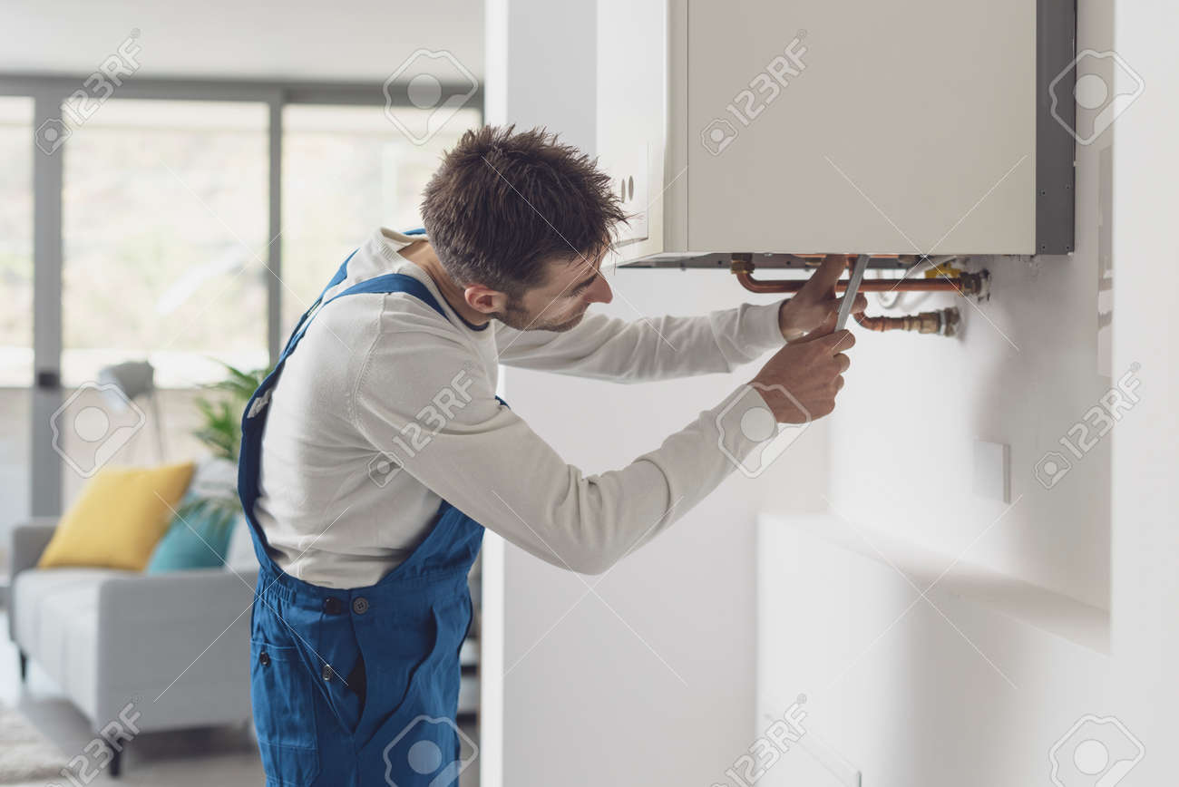 168231976-professional-plumber-checking-a-boiler-and-pipes-boiler-service-concept